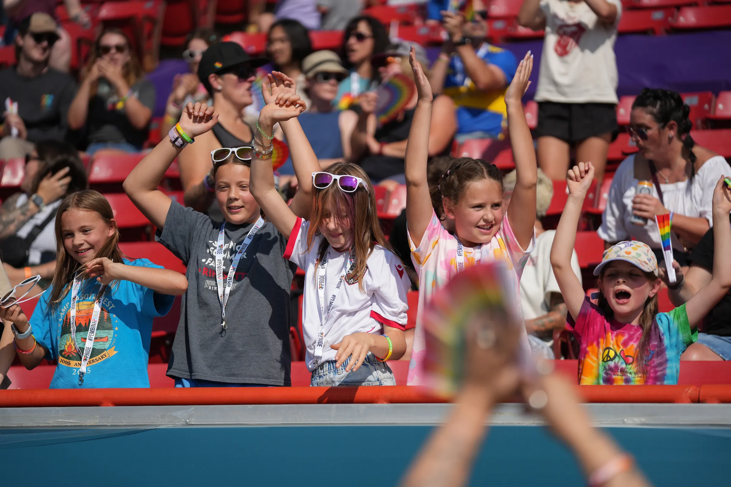 Young fans cheering in the stands during a Calgary Wild FC match