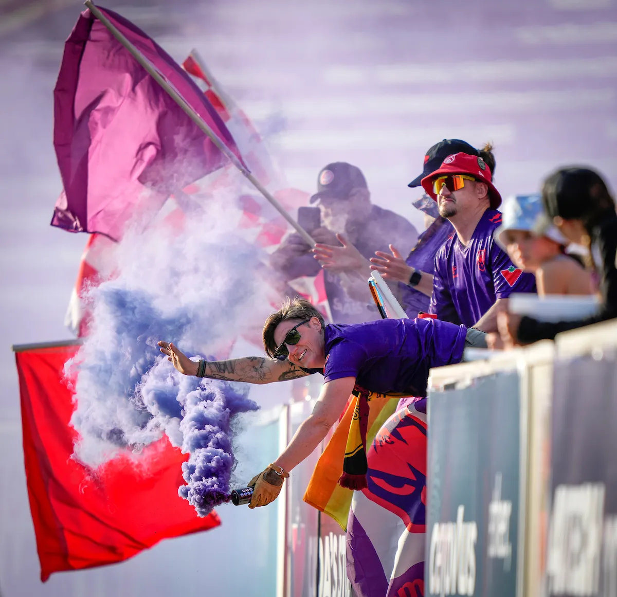 Calgary Wild FC fans celebrating with smoke bombs
