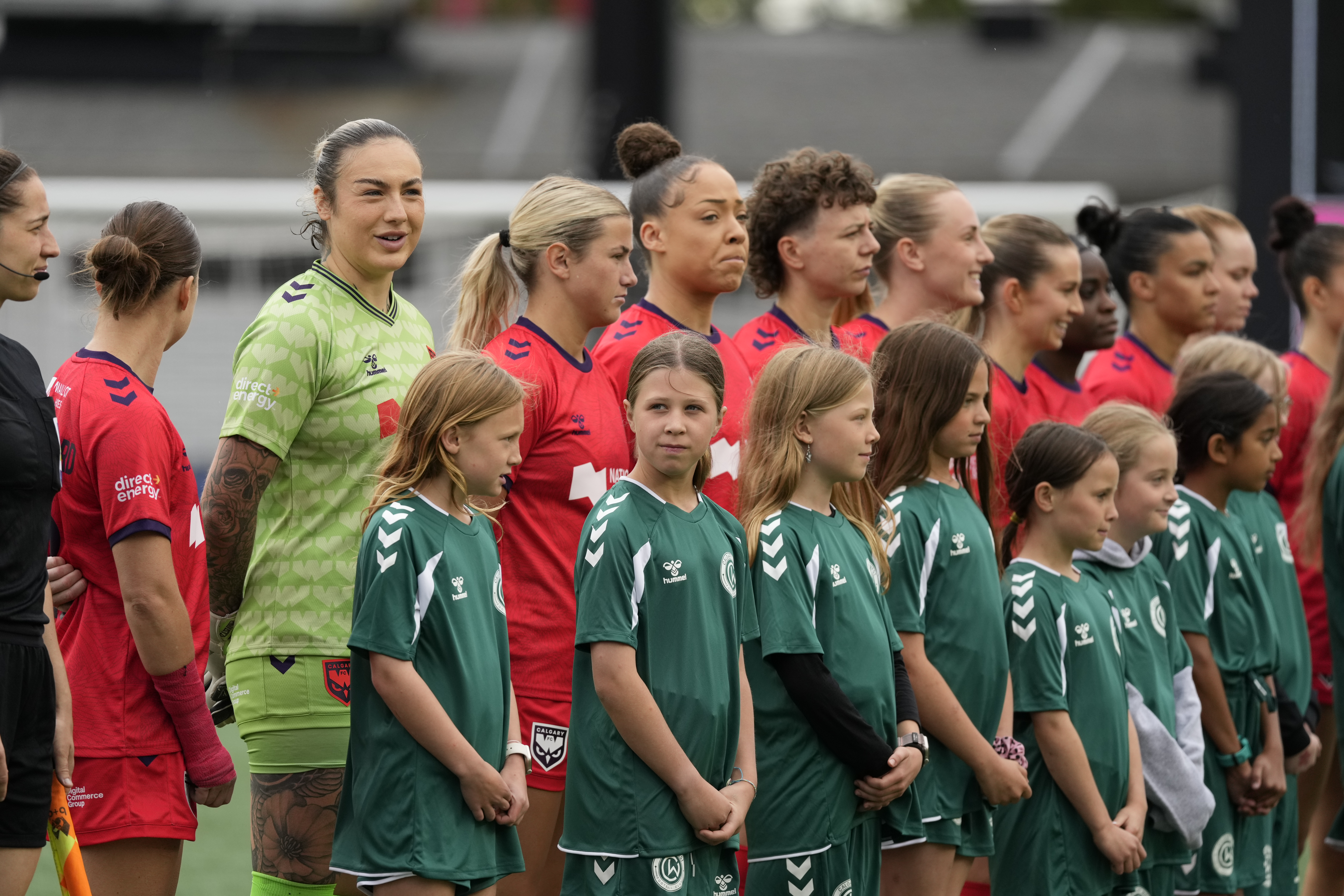 Katelin Talbert walking out with fans before a match